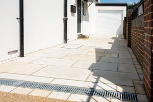 Natural stone driveway fitted with drainage channel