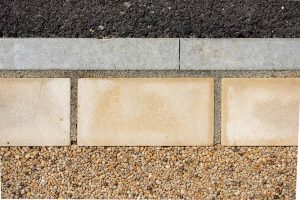 Threshold boundary with resin natural stone and tarmac